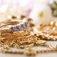 shiny gold and silver jewelery on white table